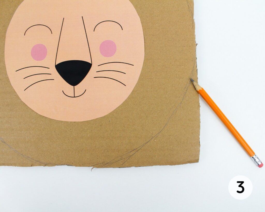 Pencil drawing a curved line in the corner of the square of cardboard.