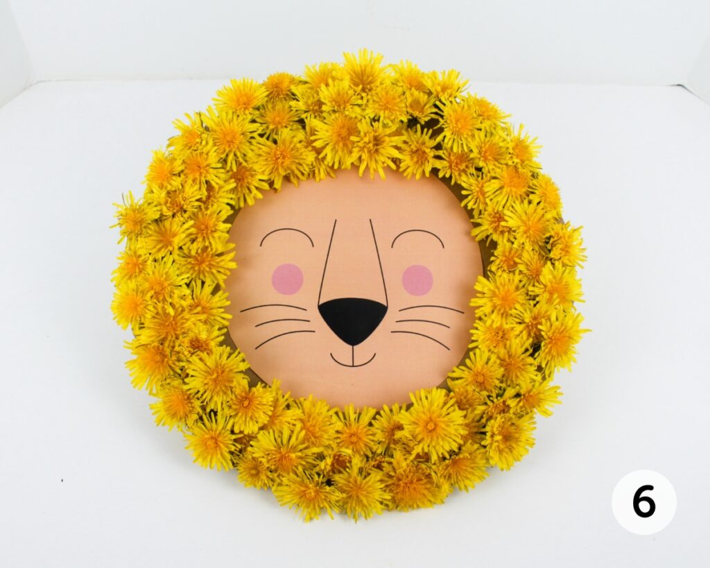Lion craft with a mane made from yellow dandelions.