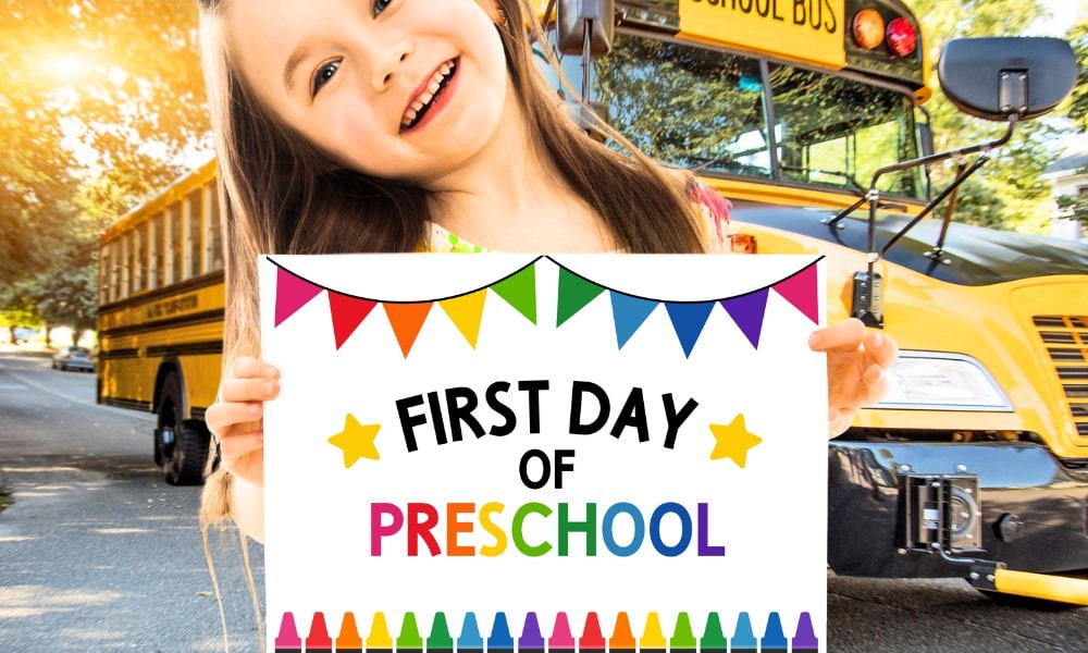 Girl holding up a sign that says "First day of preschool".