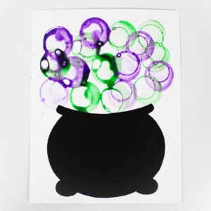 Craft with purple and green bubbles above a black cauldron.